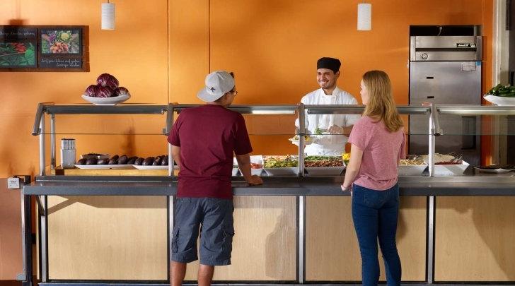 Pitzer students talk with a chef in McConnell Dining Hall