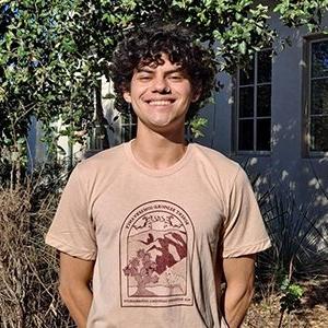 Headshot of Danilo Estigarribia, who has short curly dark hair and wars a Redford Conservancy T-shirt.