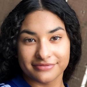 Headshot  of Hailey Rodriguez, who has long wavy black hair.