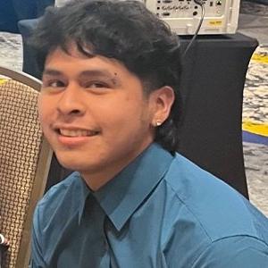 Headshot of Matthew Jaime Morelos, who has short black hair and wears a blu collared shirt.