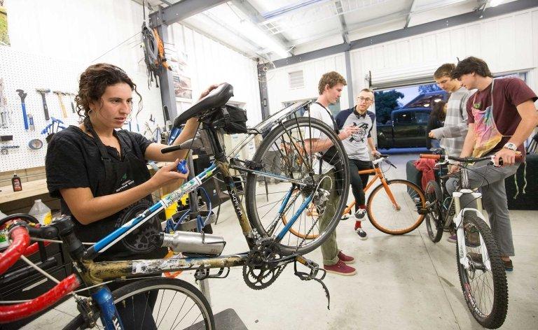 five students work on bikes